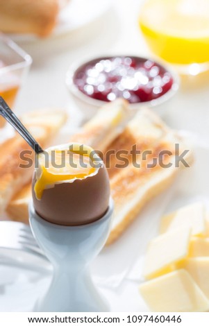 close up picture of breakfast table with yolk egg and toast
