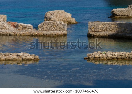 sea dock with wall and rocks. Antibes. France