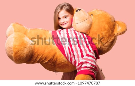 little pretty girl holding a teddy bear. happy expression
