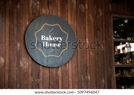 Black sign on a wooden wall mockup