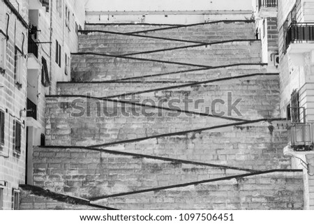 Street with stairs on the island of Malta. Black and white picture