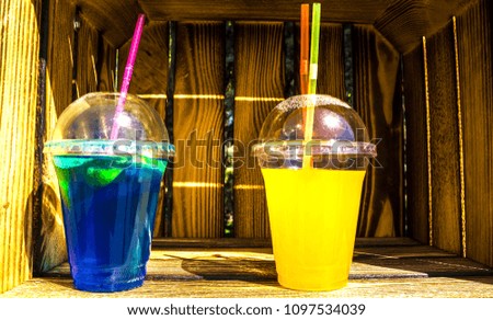 Two cocktails with tubules on the shelf