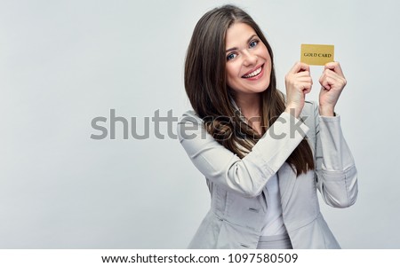 Smiling business woman holding credit card near face. isolated studio portrait.