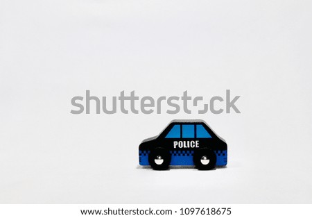 Miniature police wooden blue car with white background