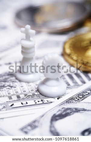 Chess pieces with bitcoins on US dollars background, conceptual photography, money game                 
