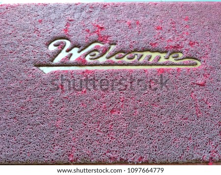 Message"Welcome"on old and grunge with textured of red rubber doormat