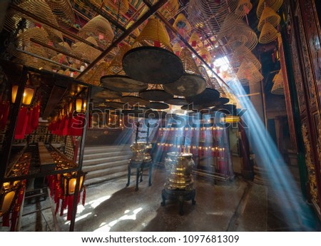 Light penetrates through the thick incense smoke in Central Hong Kong's Man Mo Temple.