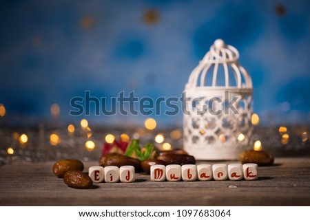Congratulation EID MUBARAK composed of wooden dices. Closeup Royalty-Free Stock Photo #1097683064