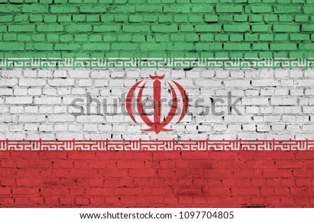 Iran flag is painted onto an old brick wall