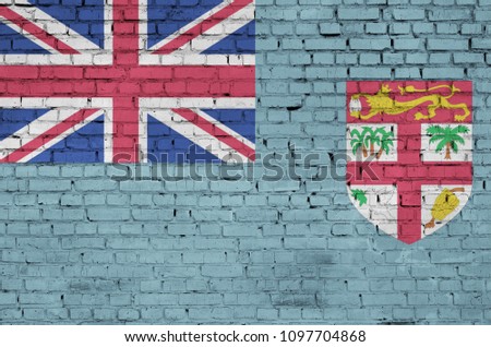 Fiji flag is painted onto an old brick wall