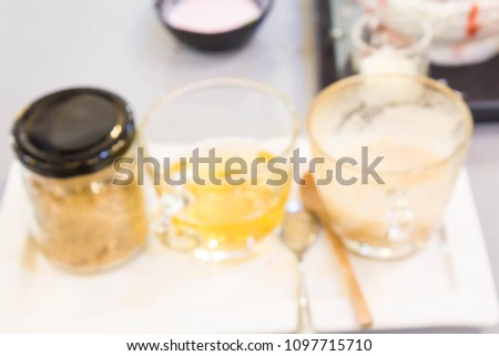 Blurry coffee and dark tea in clear glass. Left glass with a white background.
