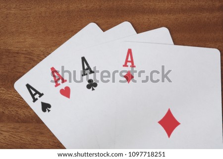 Aces on wooden table close up