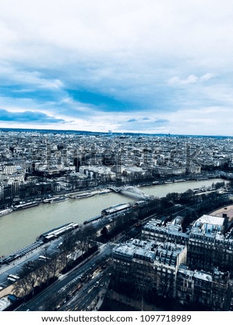 Paris, France - December 2017 - An aerial shot from the Eiffel Tower with Seine river right in the middle. Paris is a hub of finance, fashion, science and arts and history.