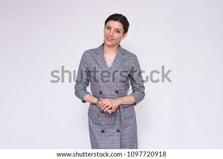 Let's talk about this. Portrait of a beautiful business woman manager on a white background. She is right in front of the camera smiling and looks attentive