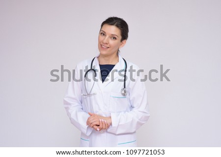 Tell me about your illnesses. Portrait of a beautiful female doctor on a white background with an endoscope. She is standing right in front of the camera smiling and looks attentive
