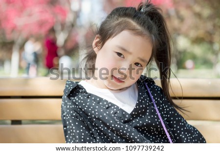 The lovely little girl in Asia is in the park
