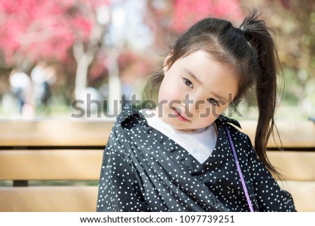 The lovely little girl in Asia is in the park
