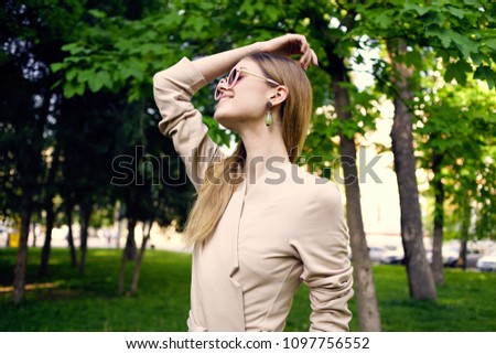 green earrings, woman in the park                              