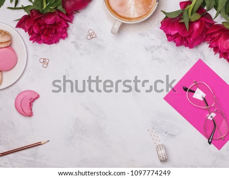 Coffee, pink peonies and beautiful feminine accessories on the marble background, top view.