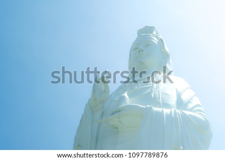 Majestic view of the Lady Buddha statue (the Bodhisattva of Mercy) at the Linh Ung Pagoda, Danang (Da Nang), Vietnam. White Ladybuddha statue (the Bodhisattva of Mercy) on blue sky background