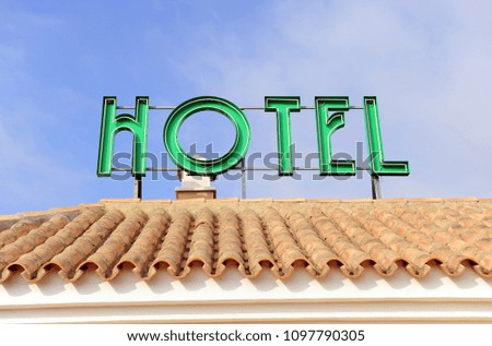 Hotel signal placed on the roof, bright green neon