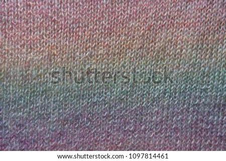 Vertical rainbow gradient on handmade knitted fabric