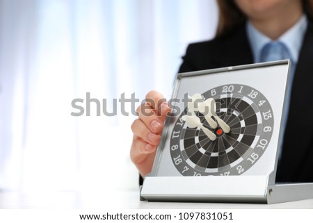Woman with darts at table. Business trainer concept