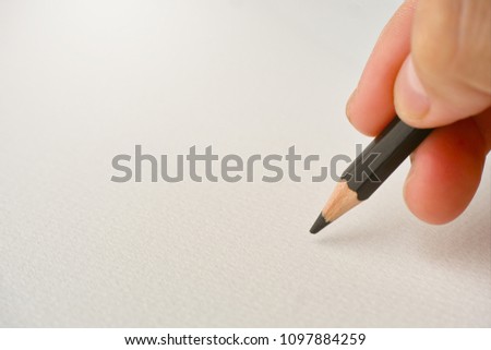 Hand writing with pencil on white sketch paper background with free space for showing message or sketching design