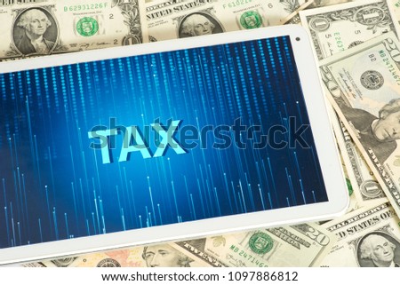 Dollar bills, tablet pc and the tax