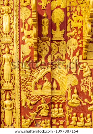 24 Golden sculptures decorated on the red wall depicting the story of the Lord Buddha and his followers