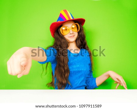portrait of a young angry woman pointing at you with a finger isolated on background, studio photo