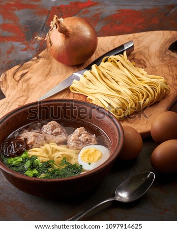 Bakso - Asian soup with noodles, eggs, green onions, sauce and meat balls. Typical Chinese, Japanese, Thai food. Ingredients for cooking tasty and rich soup for breakfast, lunch, dinner.