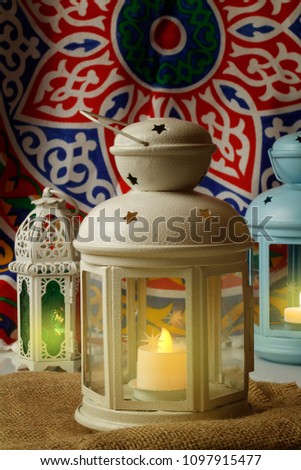 Ramadan Background - Lanterns on Ramadan colorful fabric background Royalty-Free Stock Photo #1097915477