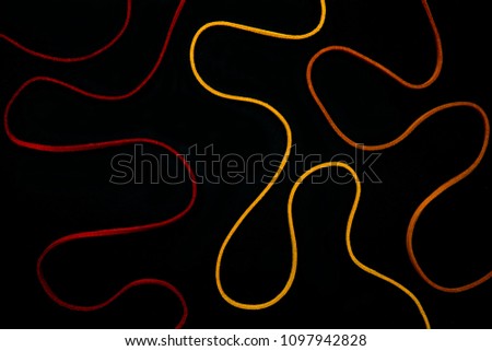 colorful thread string In various curved forms on black background.
