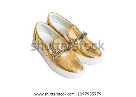 Female golden leather shoes on a white background