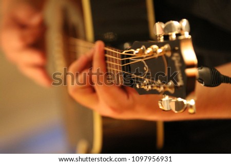 closeup of guitar player