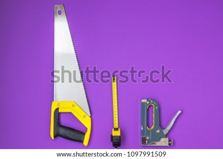 Hand tools yellow ruller, stapler, tape measure hand saw