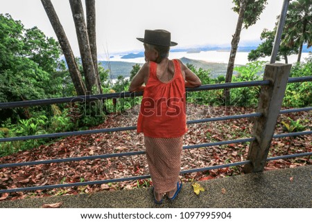 Tourists use the camera or mobile phone to record travel and promote. TRAVEL (KHAO FA CHI VIEWPOINT) The surrounding area has green trees around, can travel throughout the day is not hot. Ranong, Thai