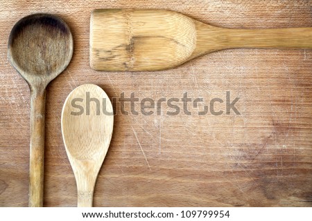 Old grunge wooden cutting kitchen desk board with spoon background