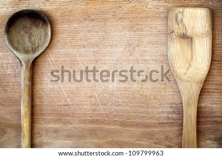 Old grunge wooden cutting kitchen desk board with spoon background