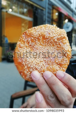 Man's hand holding a Bulgarian pastry in street of Sofia