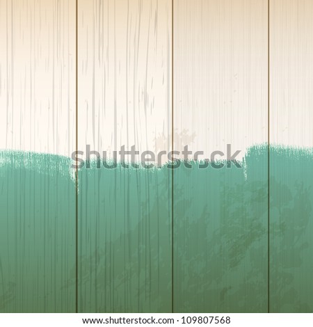wooden background with green paint strokes