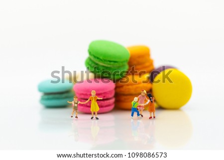 Miniature people : children playing together front sweets. Image use for happy family day concept.