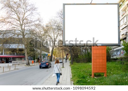 Blank billboard on the street with bright sky
