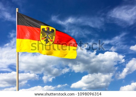 German flag. Flag of Germany (Federal Republic of Germany; in German: Bundesrepublik Deutschland) waving in the wind on a bright sunny summer day and blue sky background.