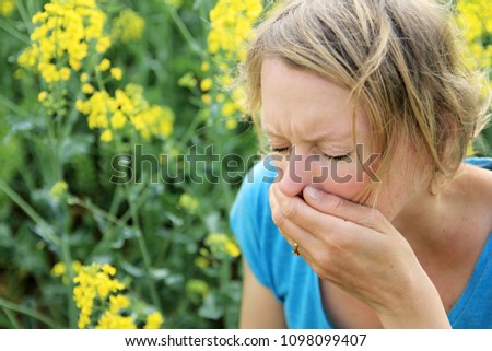 woman sneezing because of pollen stock image and stock photo