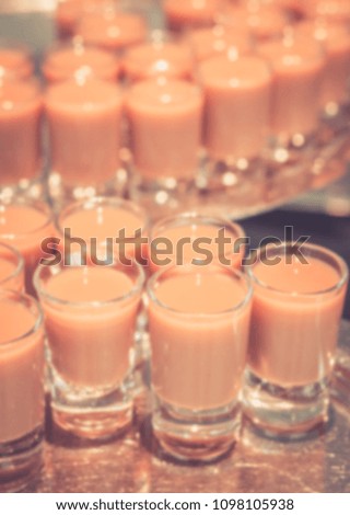 Abstract defocused and blurred healthy organic strawberries smoothies in glass for background usage