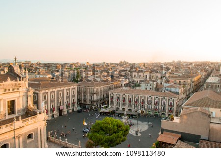 Catania, Sicily in Italy. Aerial view of the city roofs and in particoular the magnificent Duomo square at sunset, nice warm colors and soft light. Shot from the badia of Sant'Agata church
