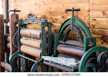 Old mangle for housework. Devices that facilitate housework in an old house. Season of the spring. Royalty-Free Stock Photo #1098137684