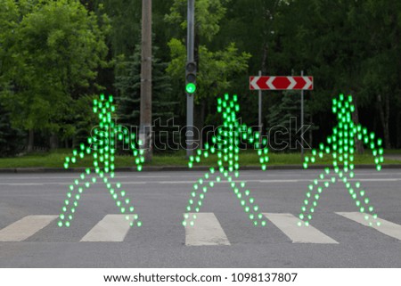 Green people walking pedestrian crossing
